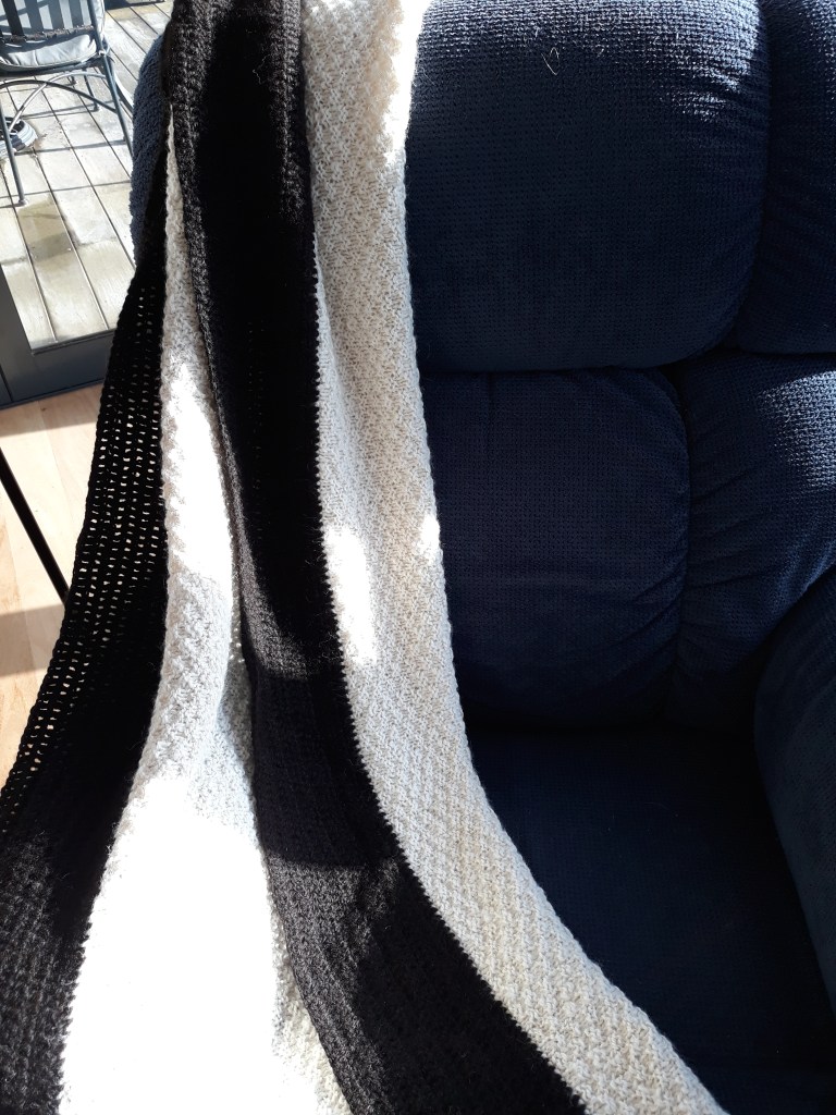 Throw rug/cot blanket, white with black edging $170 NZD